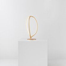 Arrival table en acabado dorado, cuerpo escultórico en forma de anillo orgánico Lámpara de sobremesa Arrival – Artemide